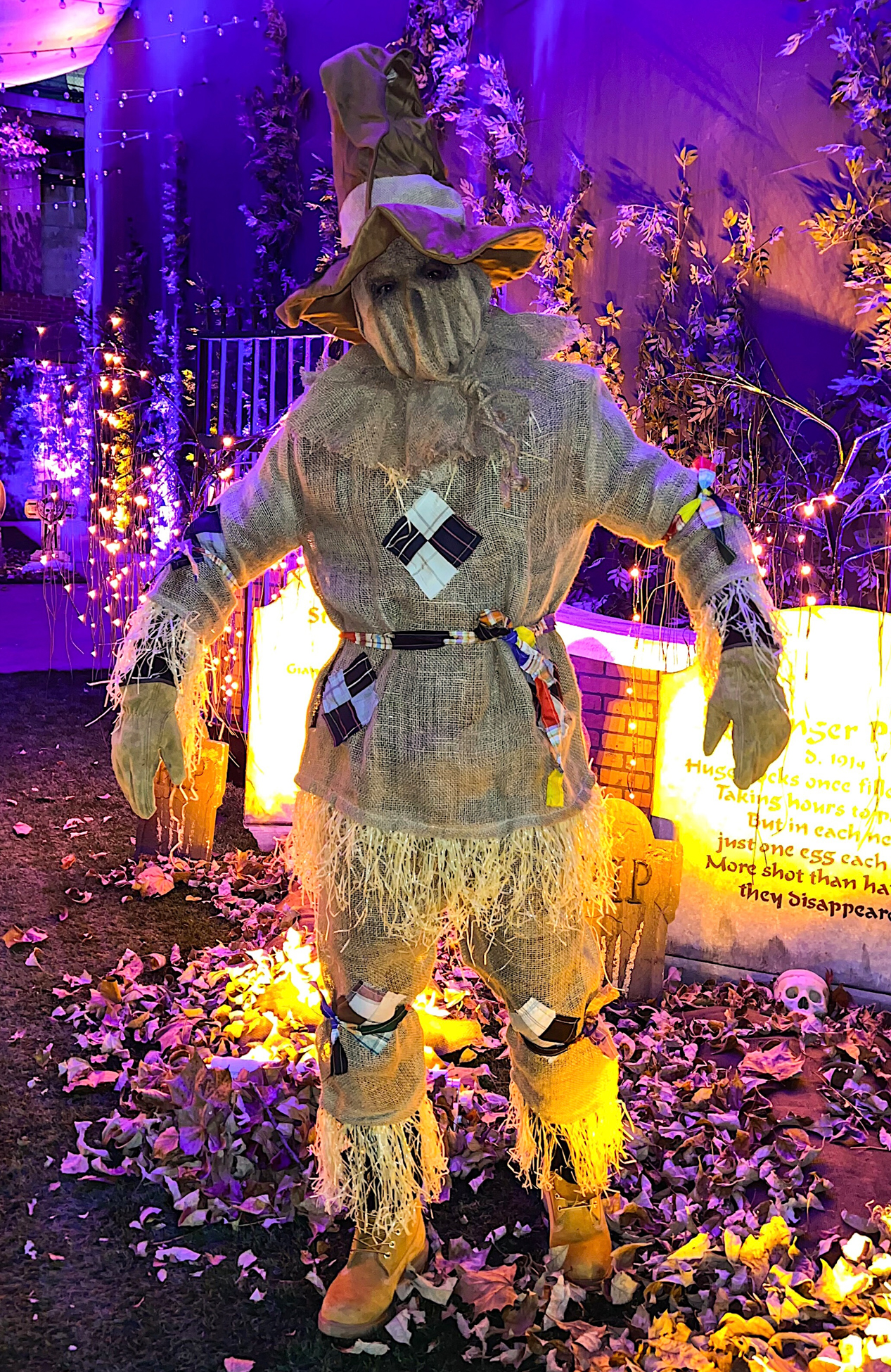 Scarecrow performer scaring guests at Halloween event