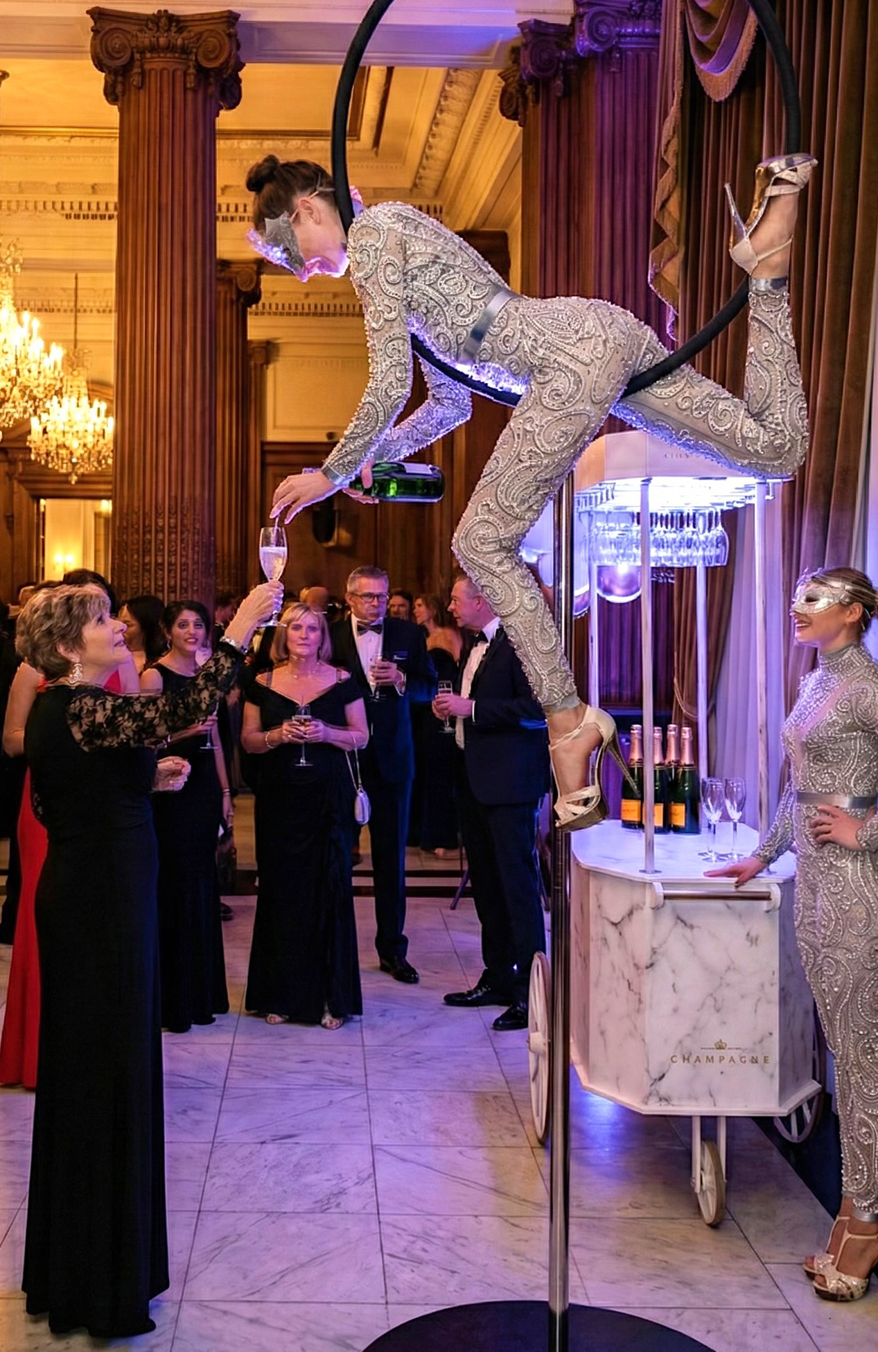 Aerialist pouring champagne for guests at a luxury gala event